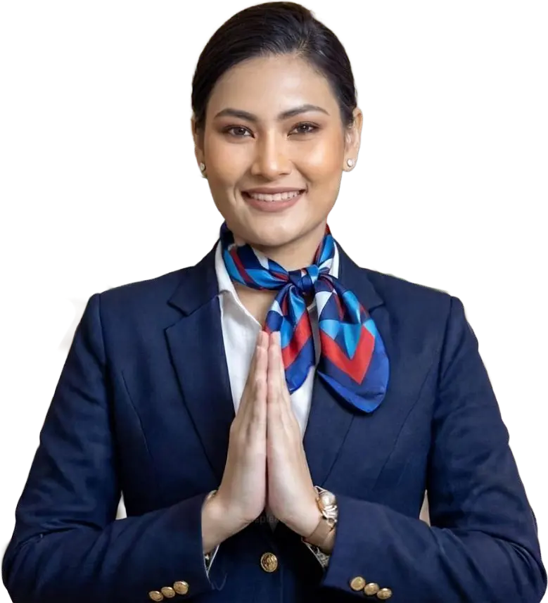 Smiling cabin crew member in a navy uniform and scarf greeting with a namaste