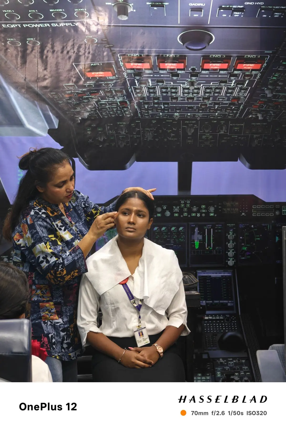Trainer styling a student's hair and make-up in the grooming studio